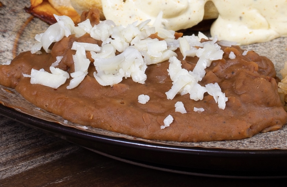 Refried beans seasoned with Lauri Lee's Ultra Low Sodium Adobo Seasoning Blend
